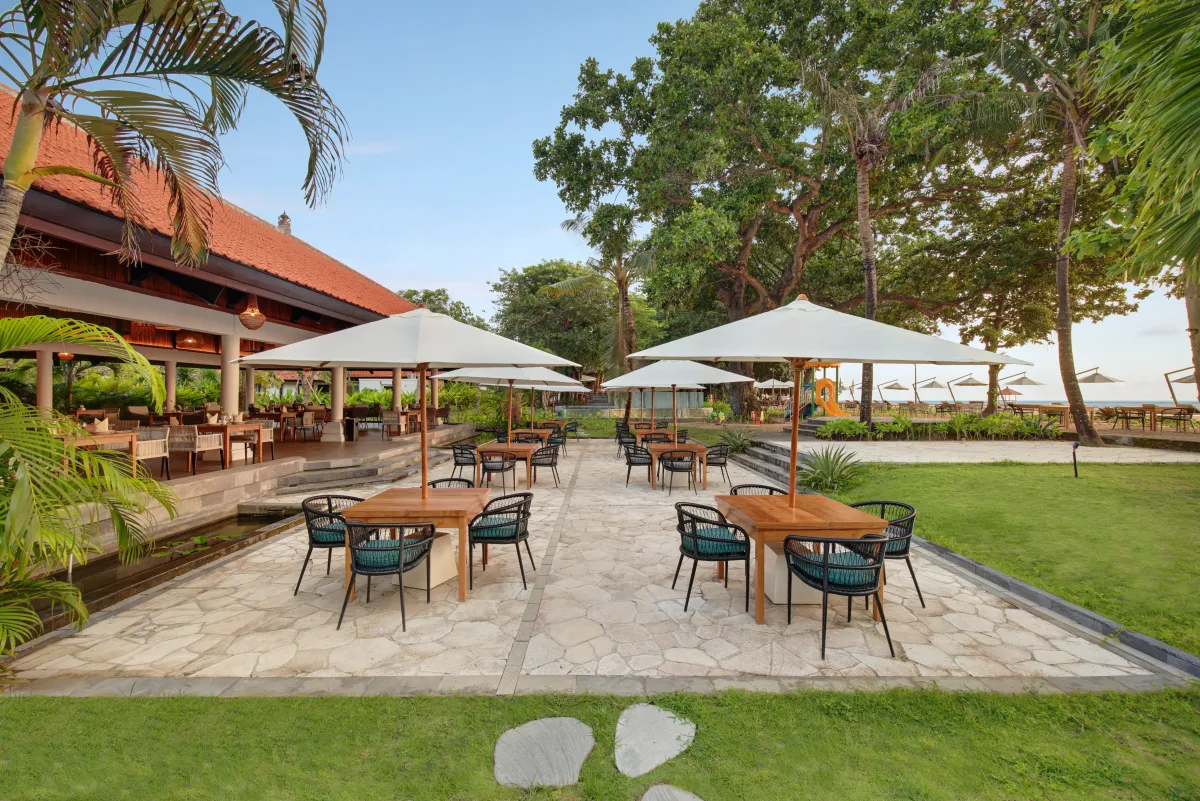 Beachside restaurant terrace under palms at éL Hotel & Resort, Sanur
